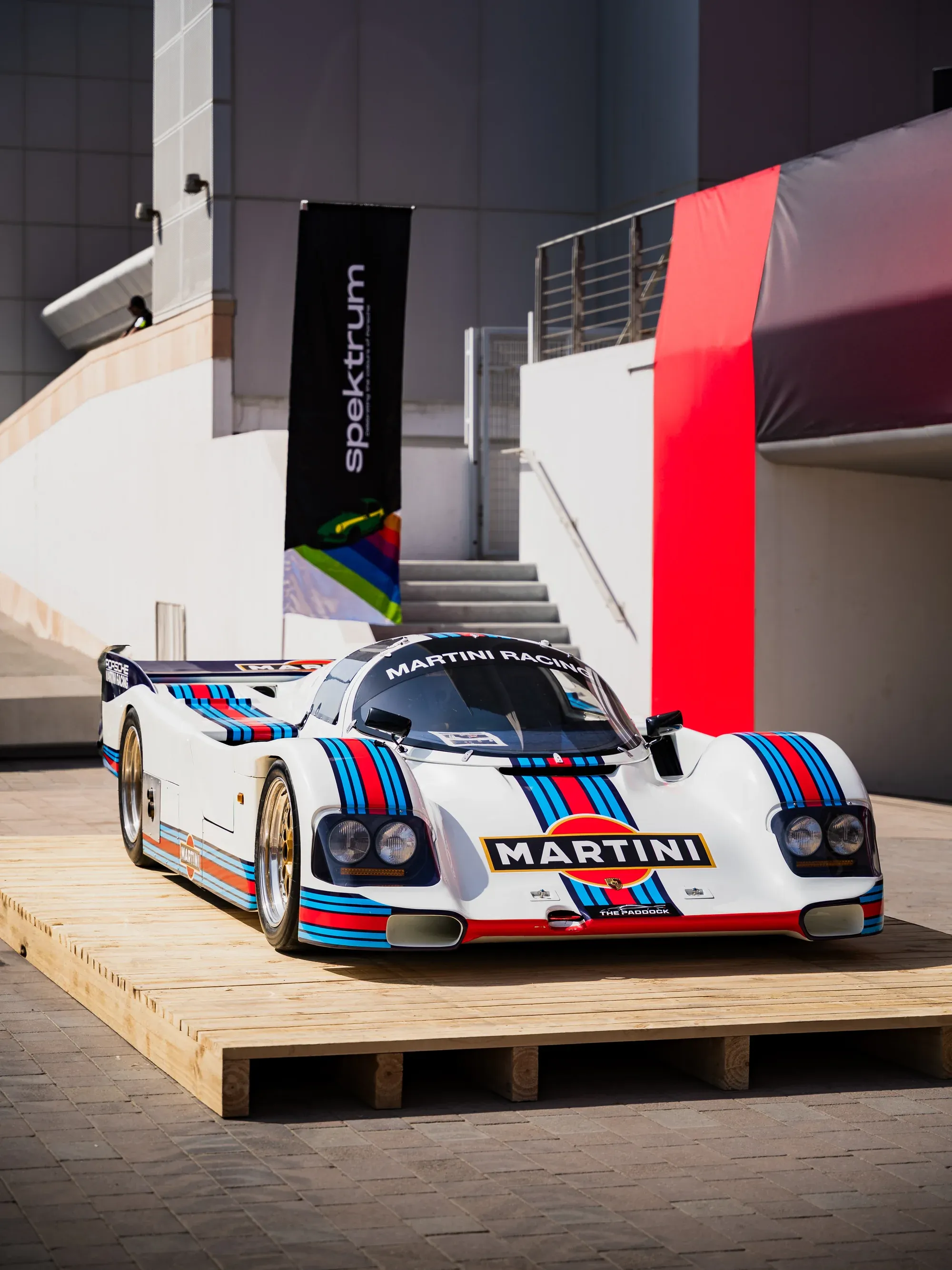 Side profile of a silver Mercedes-Benz parked in a lush green environment.