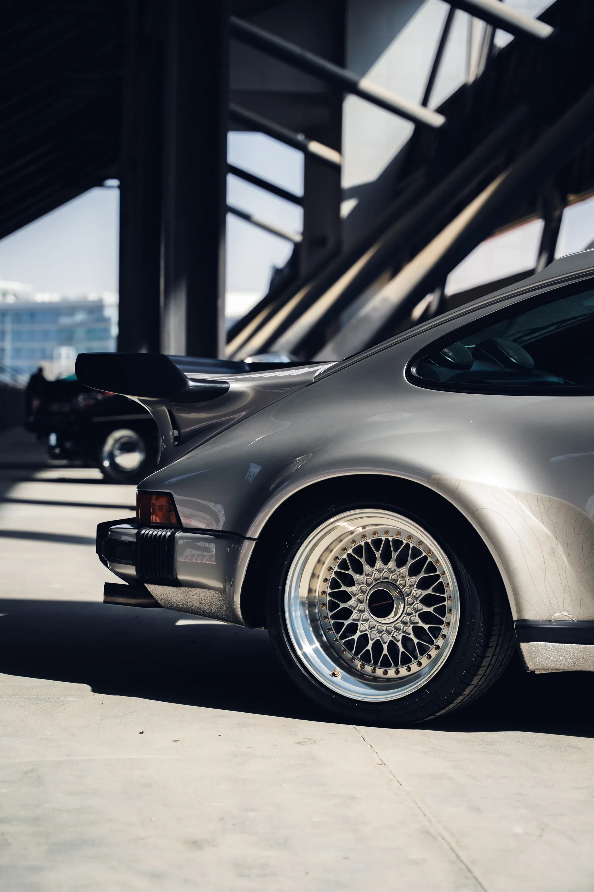 Front view of silver Mercedes-Benz W211 on a winding road.