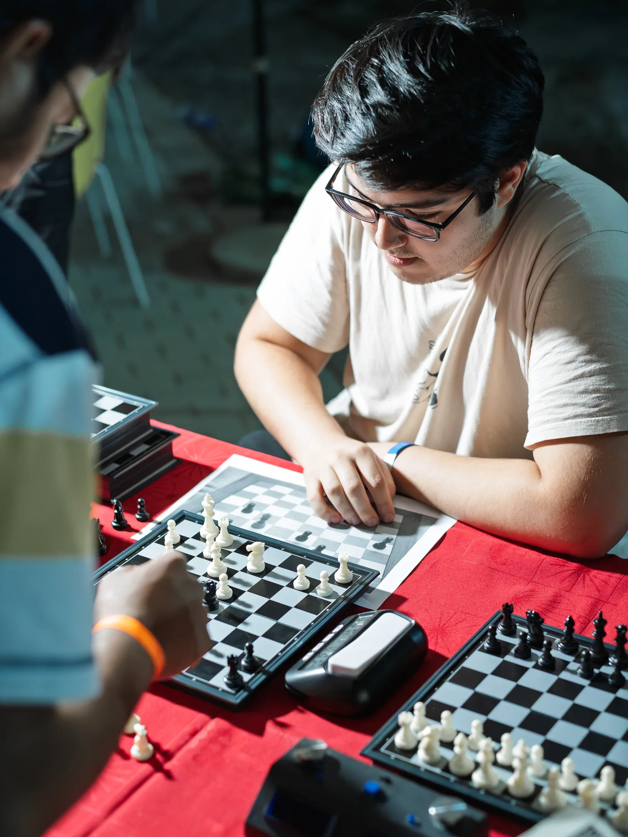 Keynote speaker on stage at a business conference, dramatic stage lighting.